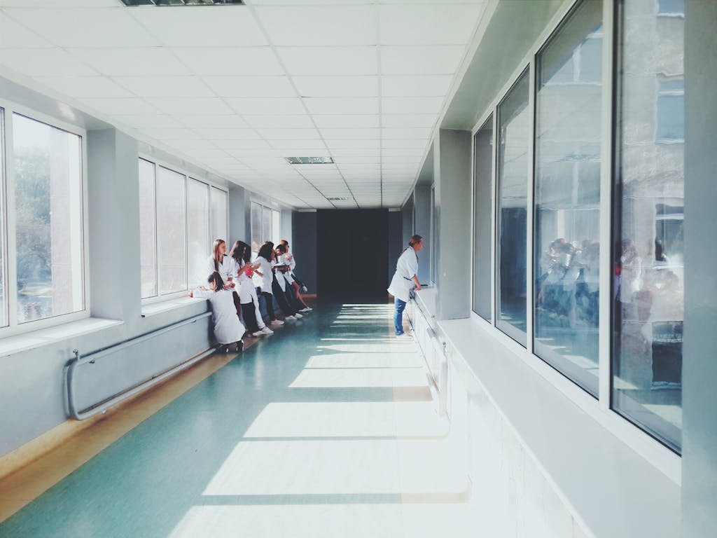 photo by oles kanebckuu A brightly lit hospital hallway with medical staff in white coats, conveying a professional healthcare environment.